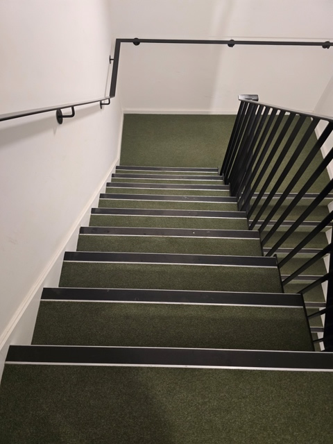 Professional communal cleaning a stairwell in Hertfordshire